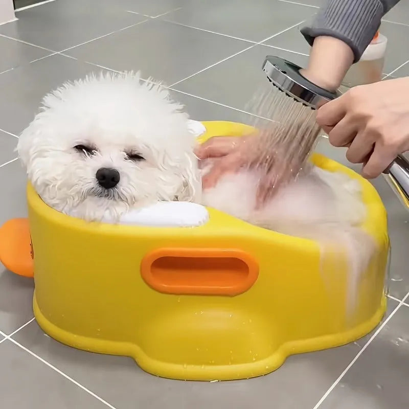 A blue PVC duck-shaped pet bathing pool for dogs and cats on a bathroom floor.