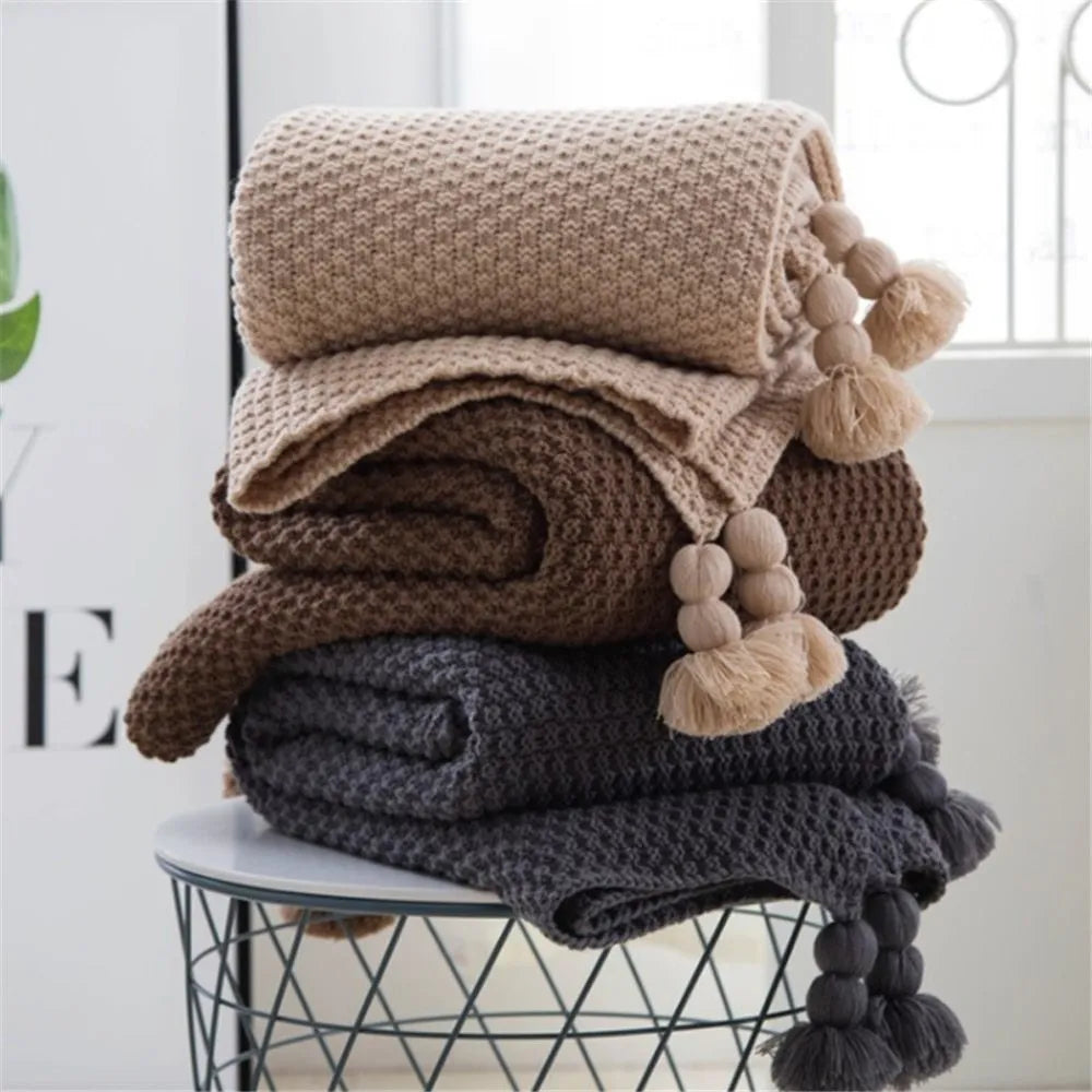 Nordic fringed knit ball blanket in beige colour showing 130×170cm dimensions and textured edge detail
