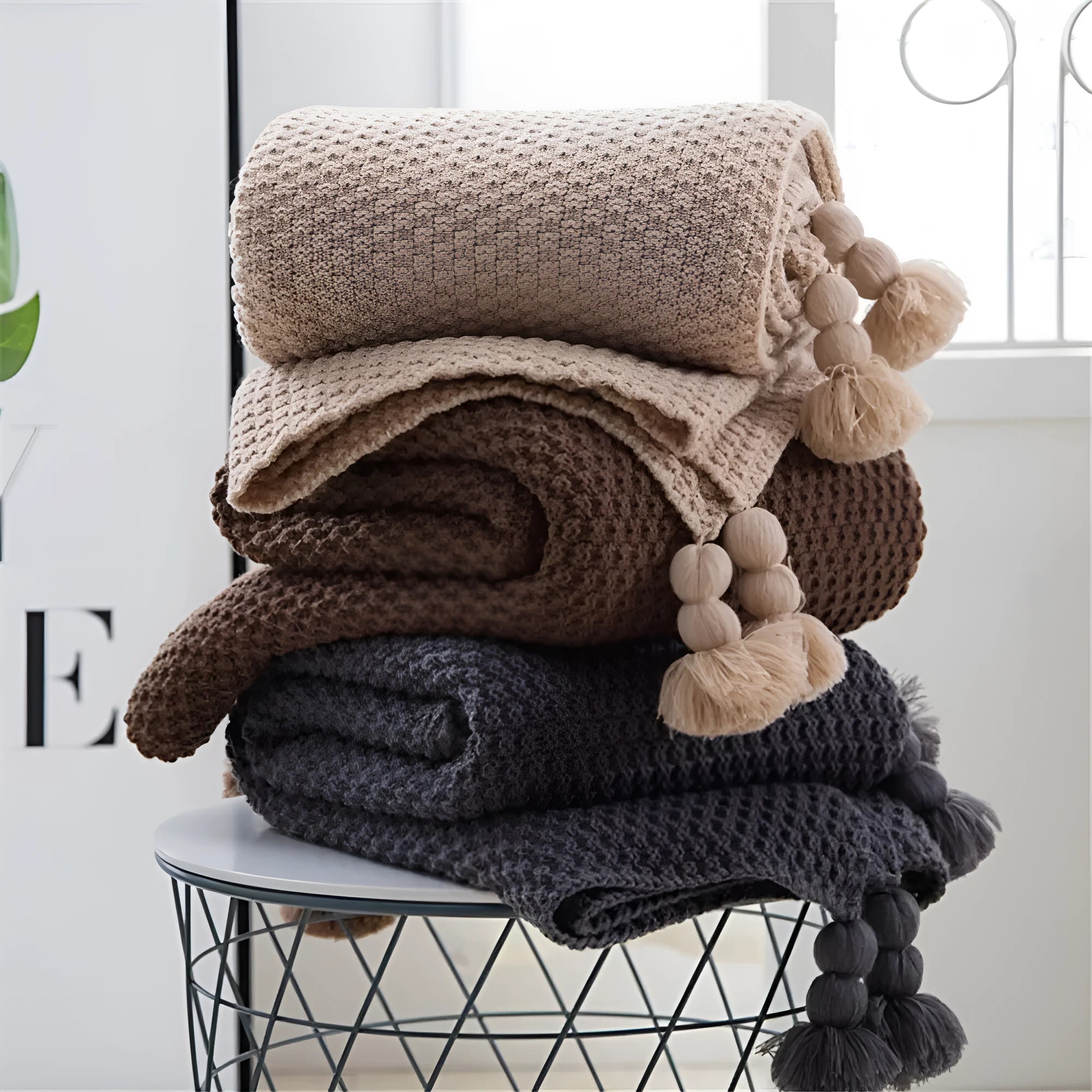 Nordic style acrylic knit blanket with ball fringe, shown in beige, dimensions 130 by 170 cm.