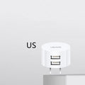White portable USB phone charger with universal international adapter for UK US and EU power sockets