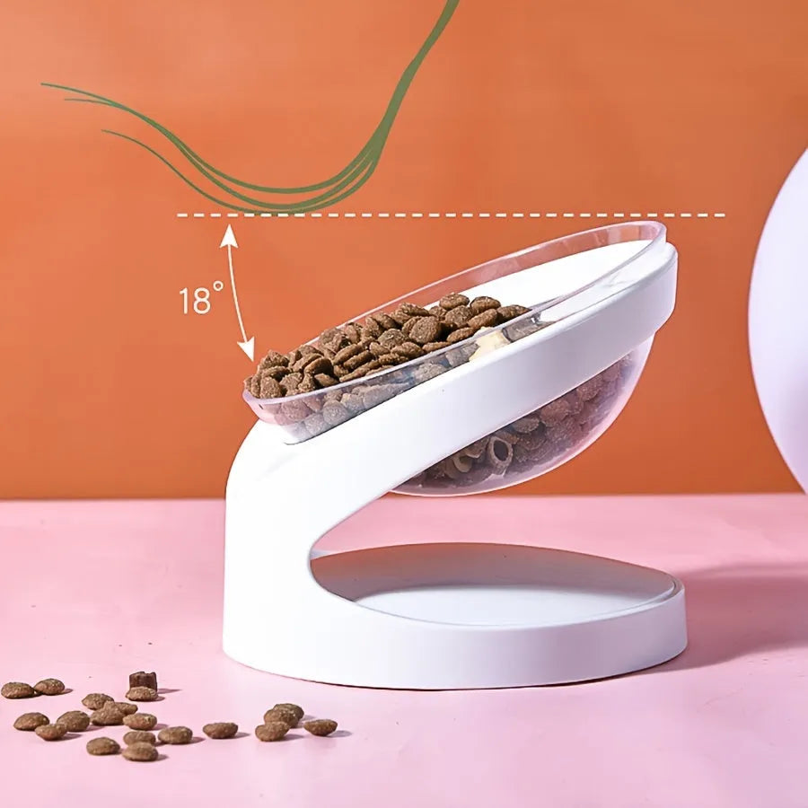 Clear elevated cat food bowl with 15-degree tilt angle on white surface