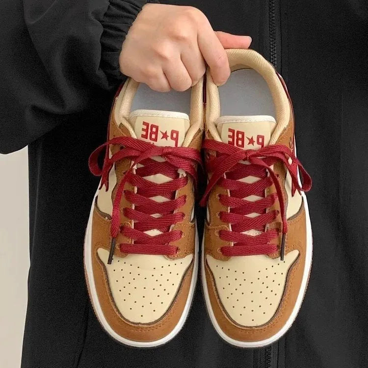 Brown low-top women's platform sneakers with sequin details and lace-up front.