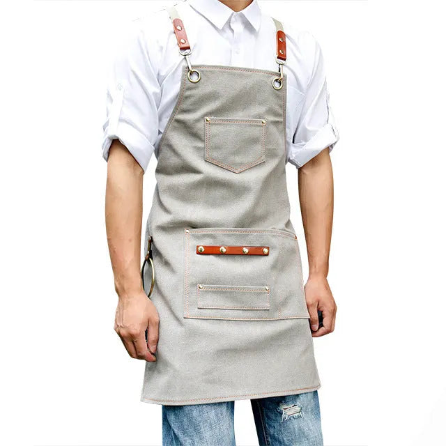 Canvas apron with cross-back straps in camel colour, shown on a person for milk tea shop or cafe use
