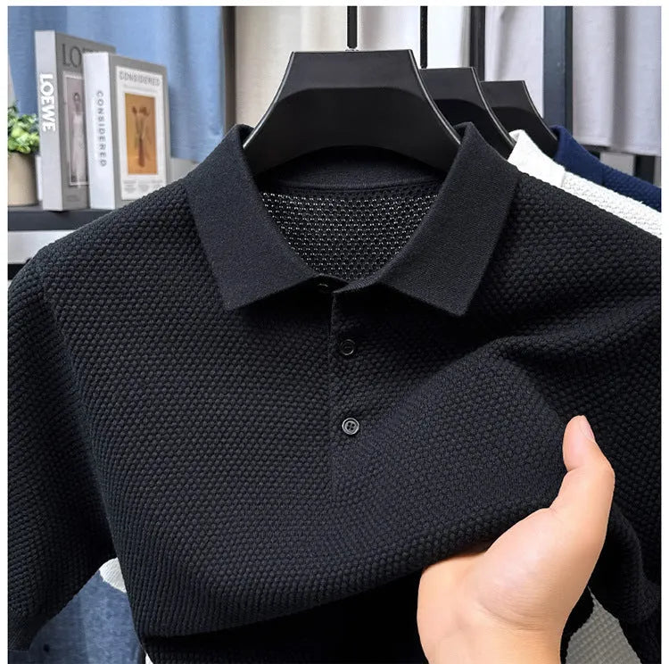 Man wearing a loose navy blue short sleeve cotton pullover sweater casually.