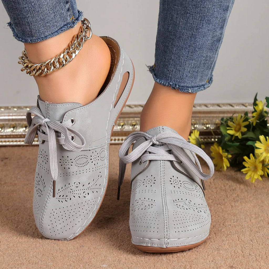Women's Baotou lace-up slippers with hollow-out wedges in suede upper and rubber sole.