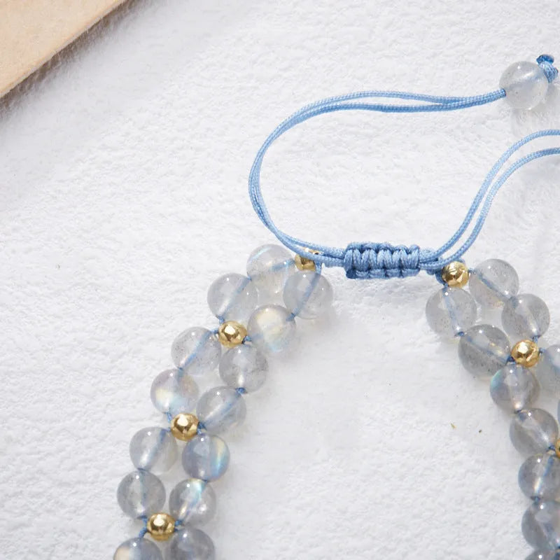 Grey moonstone bracelet with butterfly weave pattern on woven cord