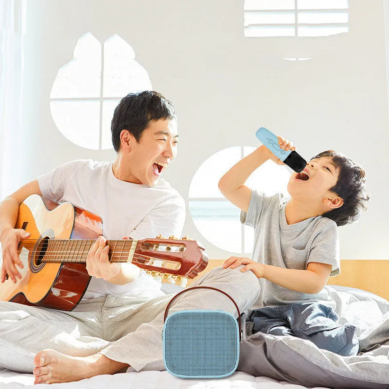 Compact white, pink, or blue portable Bluetooth speaker with USB charging cable.