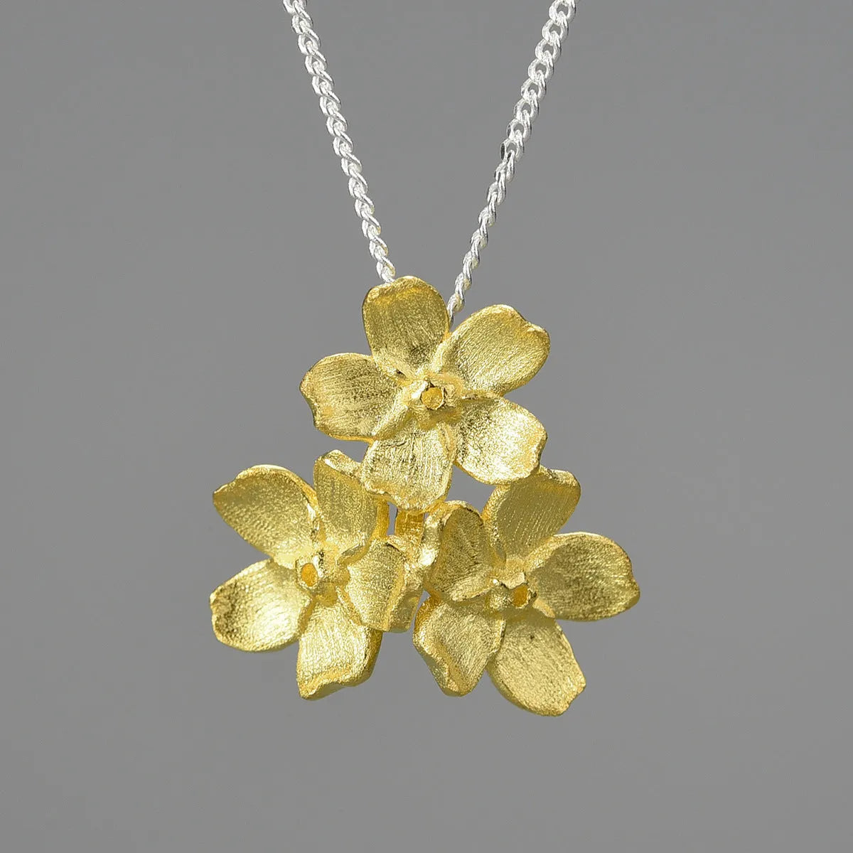 Hand-designed sterling silver forget-me-not flower pendant in pastoral style, showing open-mouth detail.
