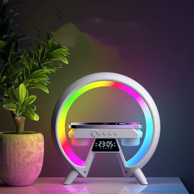Black Bluetooth bedside speaker with wireless charging pad and LED clock display on white surface