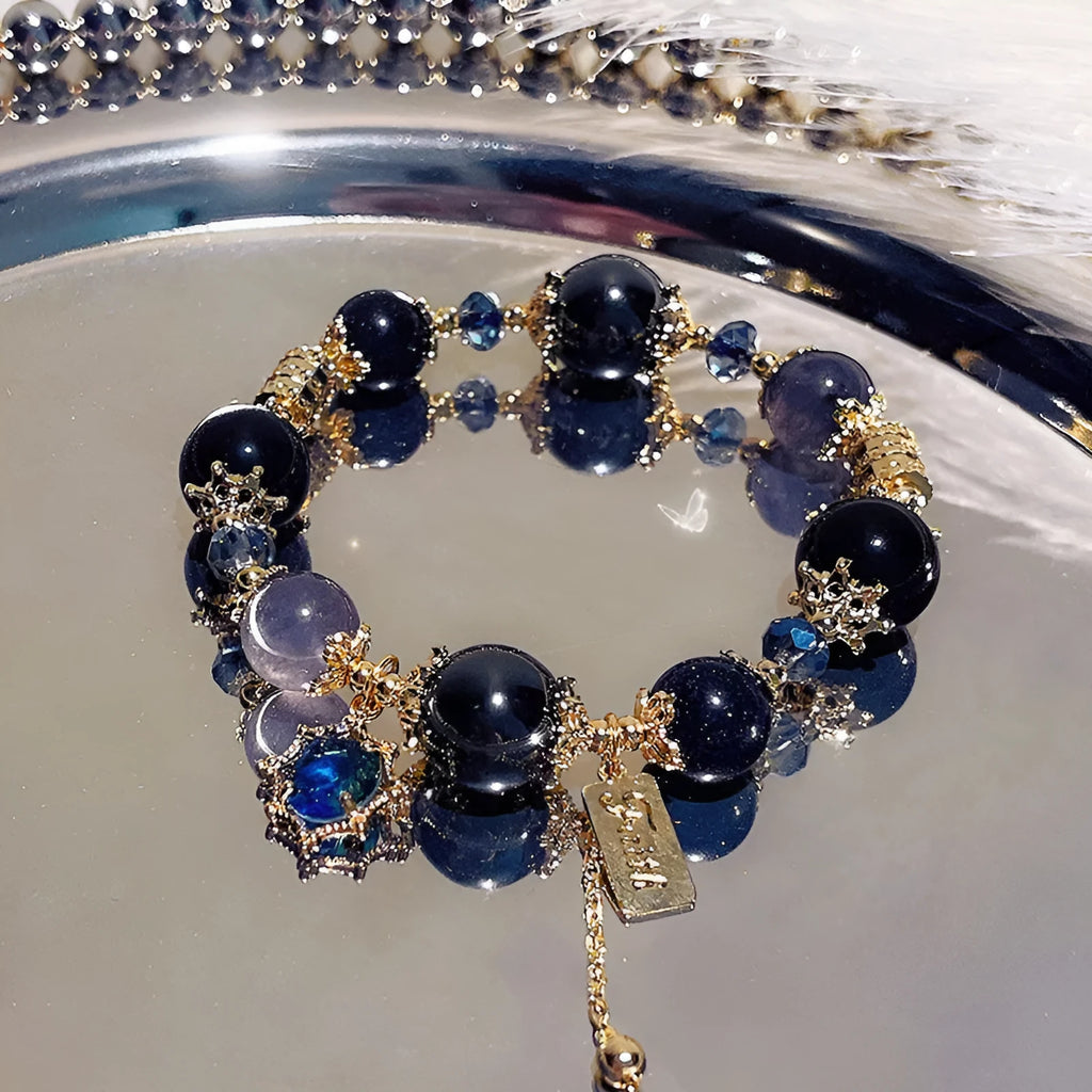 Galaxy-coloured women's alloy bracelet with snowflake pendant and bow charm.