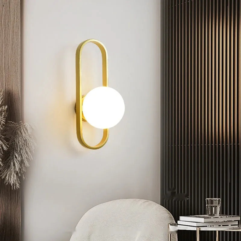 Minimalist wall lamp in black or gold with glass shade and iron body, showing 12W LED tri-colour lighting
