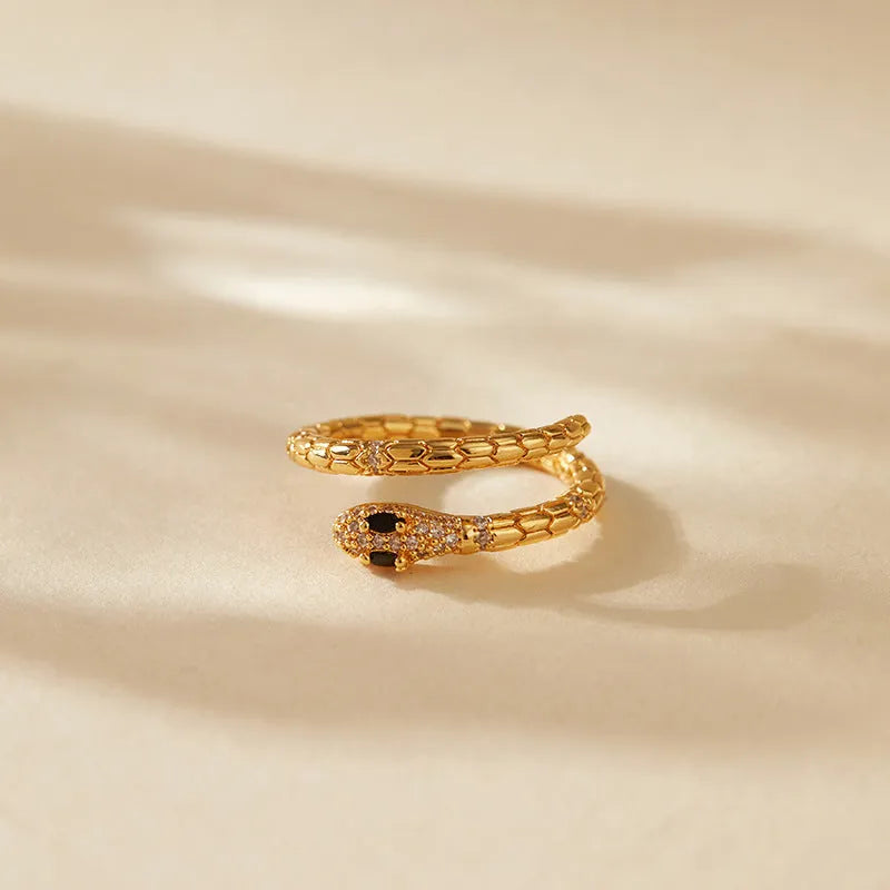 Gold coloured snake ring with open mouth design and adjustable opening