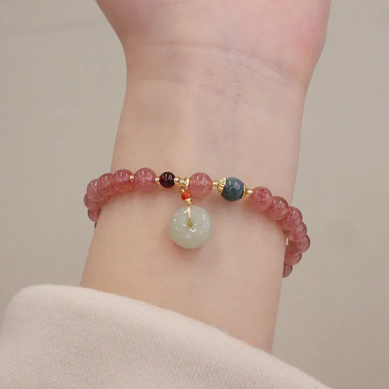 Women's strawberry quartz bracelet with geometric design, purse charm, and safety buckle closure