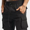 Men's black quick-dry sports shorts with four-sided stretch, shown on a model for running and fitness.