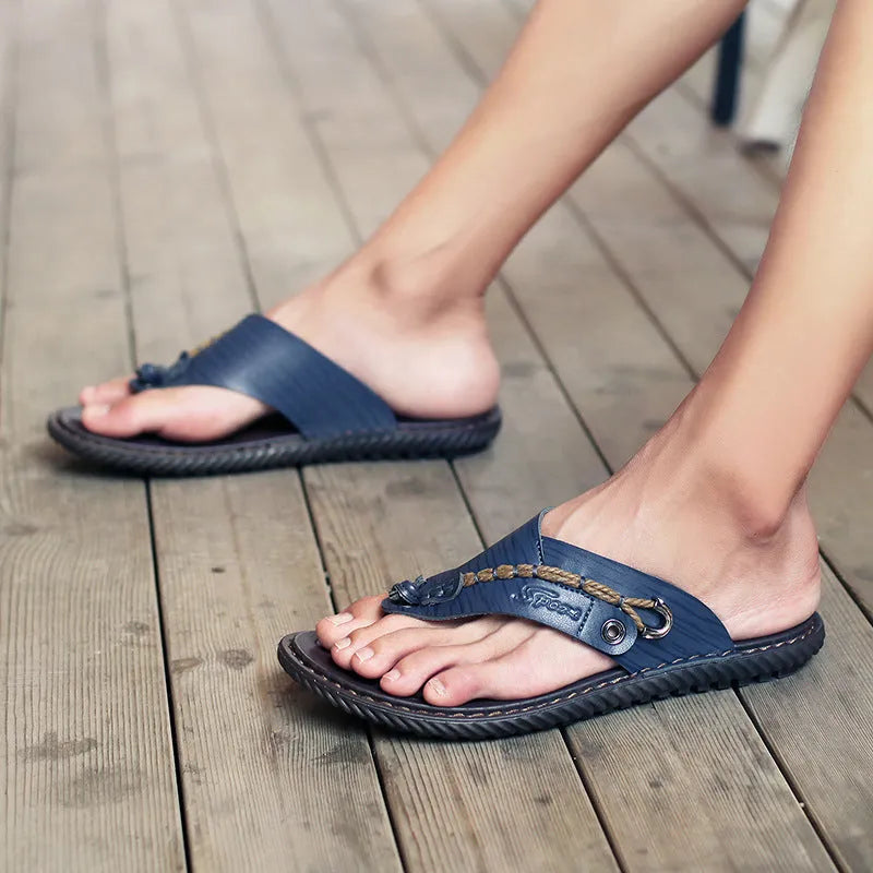 Men's black PU leather non-slip slippers showing sole traction pattern and casual design