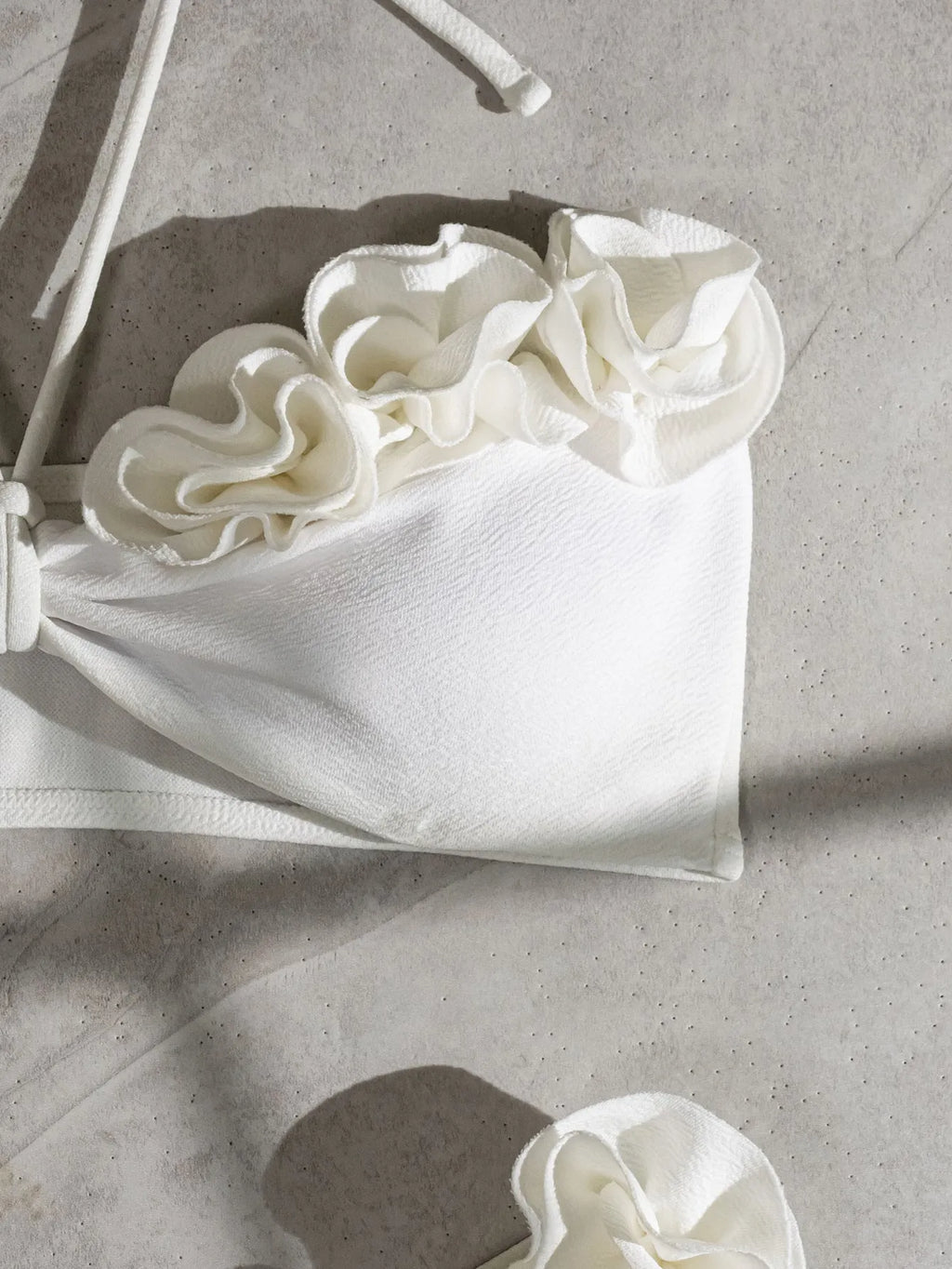 White halter neck bikini with lace-up back and three-dimensional flower detailing for swimming