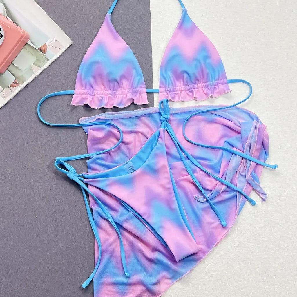Women's tie-dye patterned bikini swimsuit with a removable skirt, showing bra top and briefs.