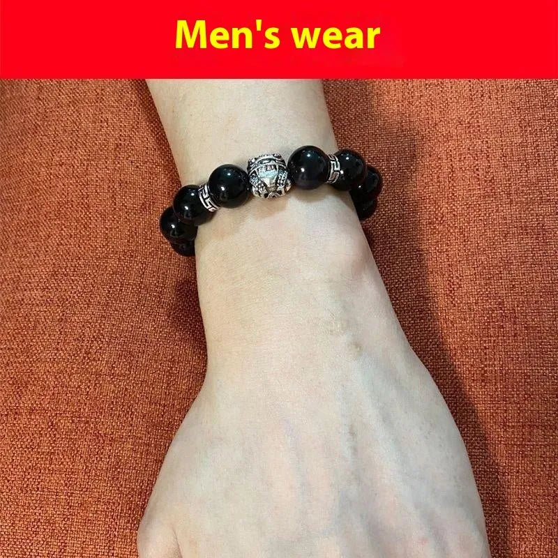 Natural obsidian and 999 silver unisex bracelet on a wrist, showing 10mm or 12mm bead size options.