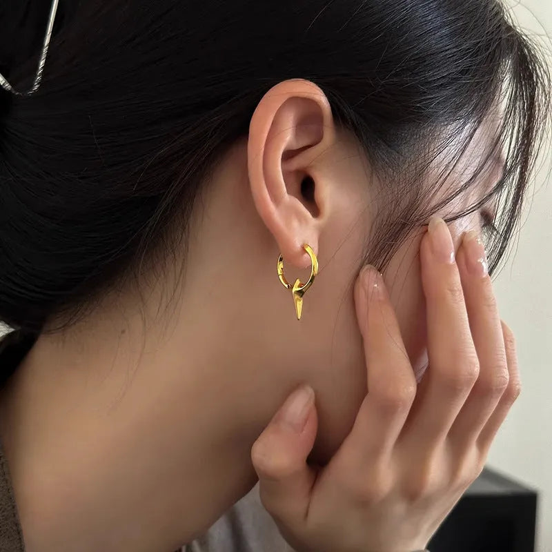 Geometric star ear clips with white gold electroplating on copper, showing secure clip mechanism and detailed star shape