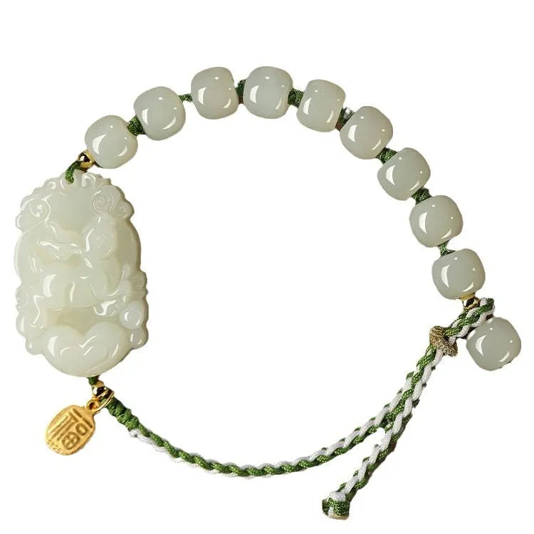 Modern red rope bracelet with a Hetian jade rabbit zodiac charm and a small silver card.