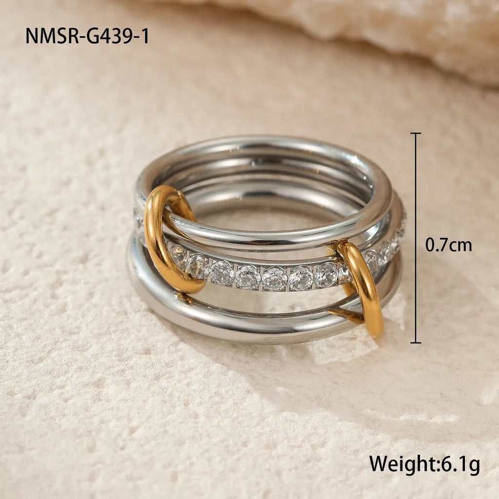 Stacked stainless steel rings with 18K gold plating in three colour variations, showing adjustable free size design