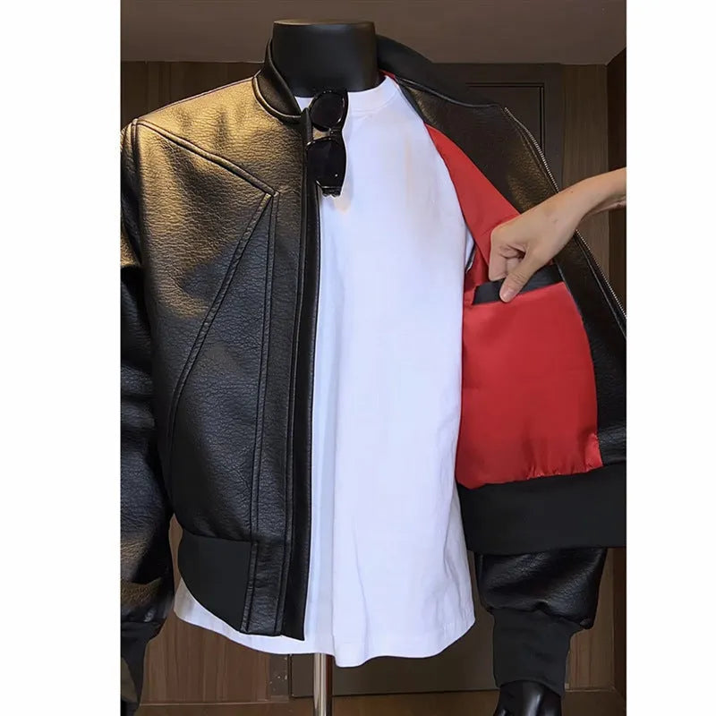 Man wearing a black PU leather jacket with litchi grain texture, showcasing its 100cm extended length and light business style fit.