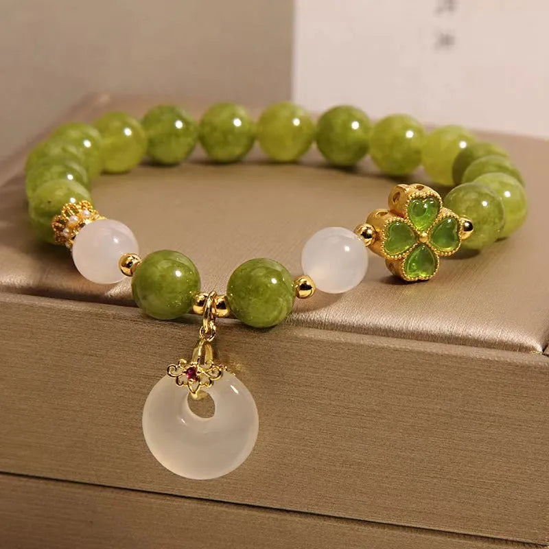 Women's green tourmaline four-leaf clover bracelet with silver electroplated finish and safety buckle clasp.