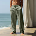 Men's loose fit casual cotton trousers in solid colours on a size chart showing S to XXXL.