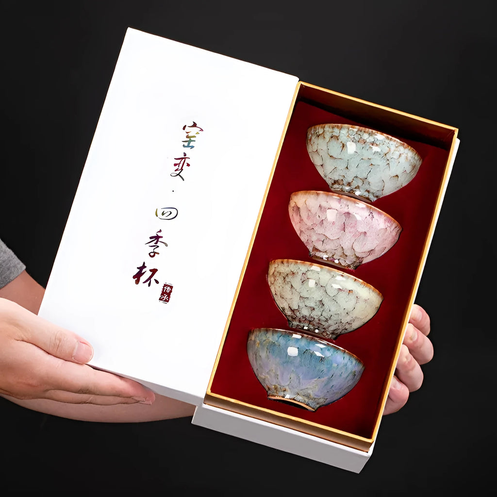 Four ceramic Gongfu tea cups in a light-coloured gift box, new Chinese style.