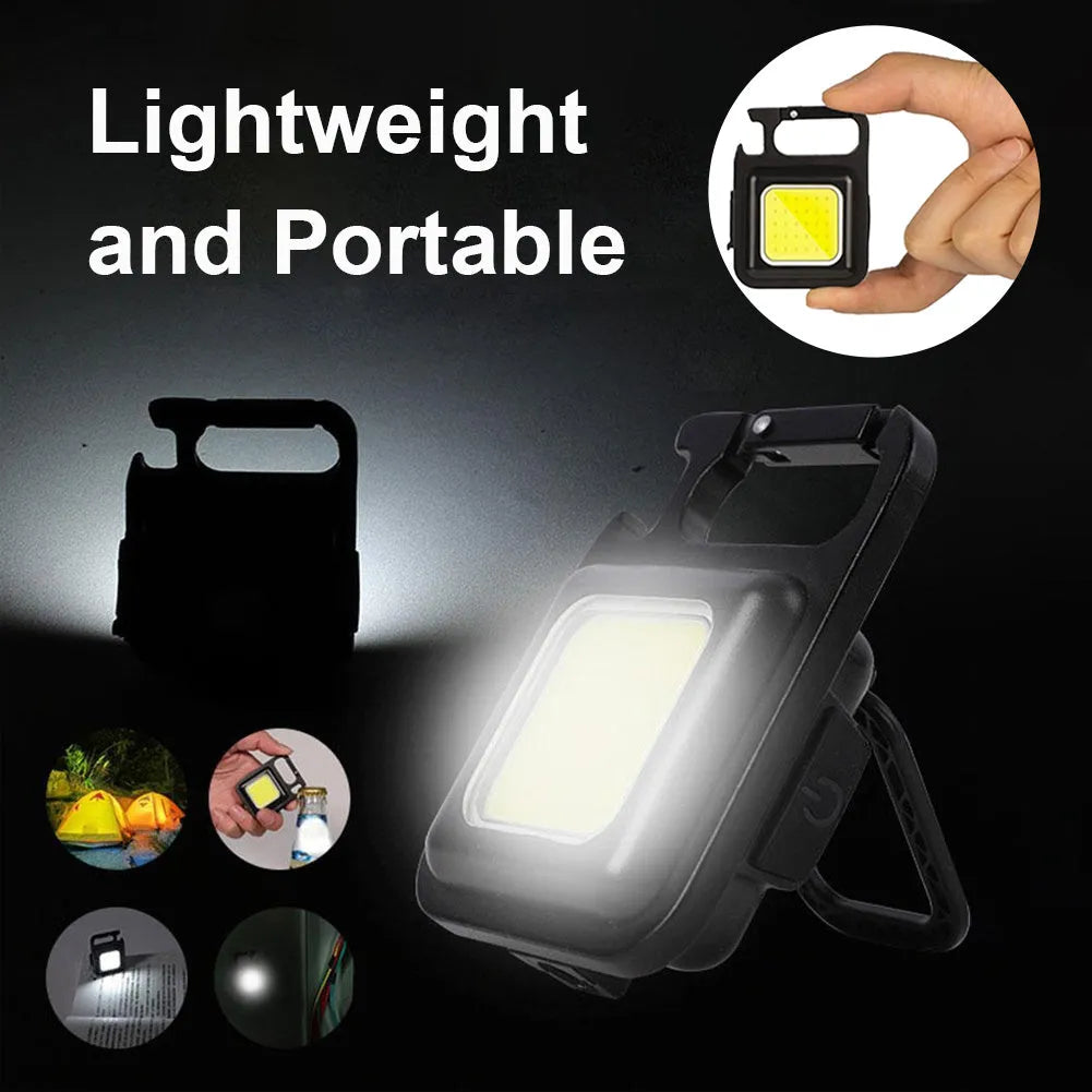 Black aluminium alloy keychain light with magnetic base and foldable handle, measuring 6 cm by 4.2 cm