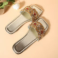 Gold women's flat slippers decorated with rhinestones and sequins on a PU upper with a rubber sole.