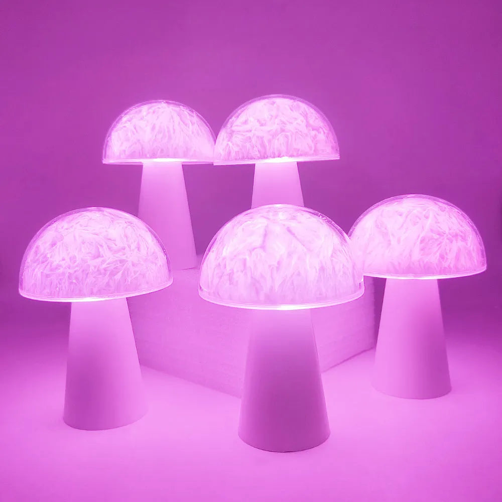 Colourful mushroom-shaped night lamp with remote control on a wooden surface.