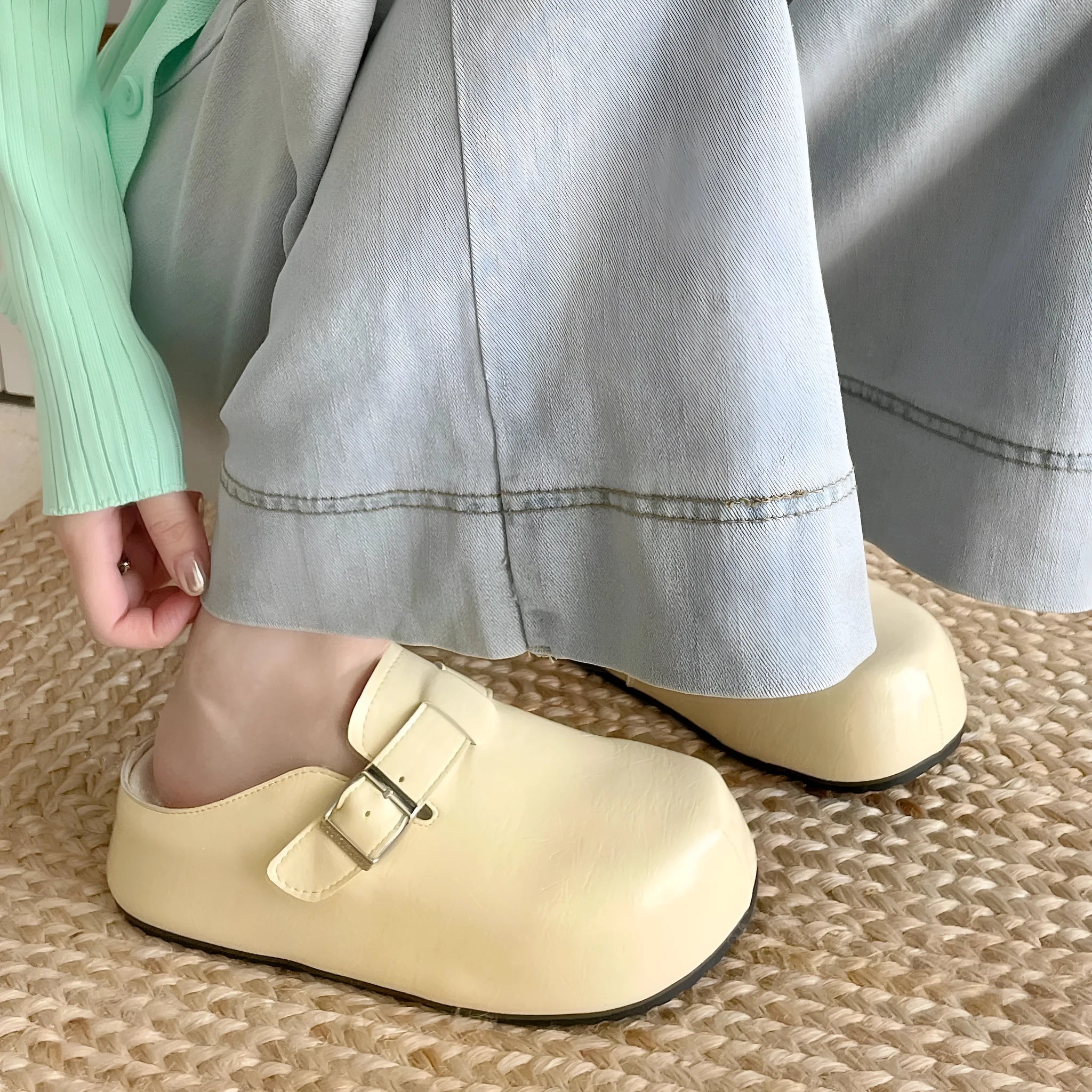 Flat buckle casual sneakers in yellow, creamy-white, silver, and black colours, showing round toe and PU upper.