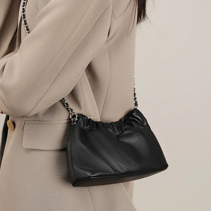Women's genuine leather crossbody bag with chain strap in Black, Milky White, and Elephant Grey colours.