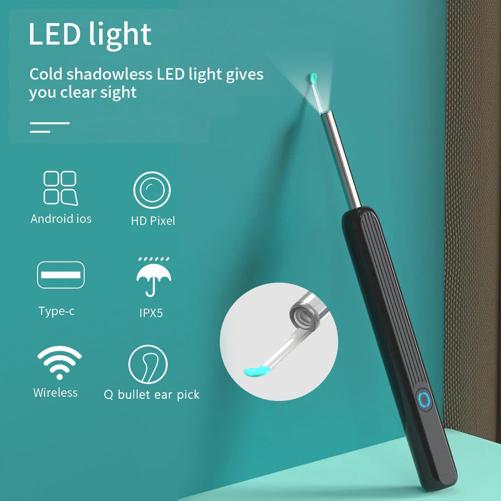 Black and white wireless otoscope ear cleaner with camera, LED light, and spoon heads on a table.
