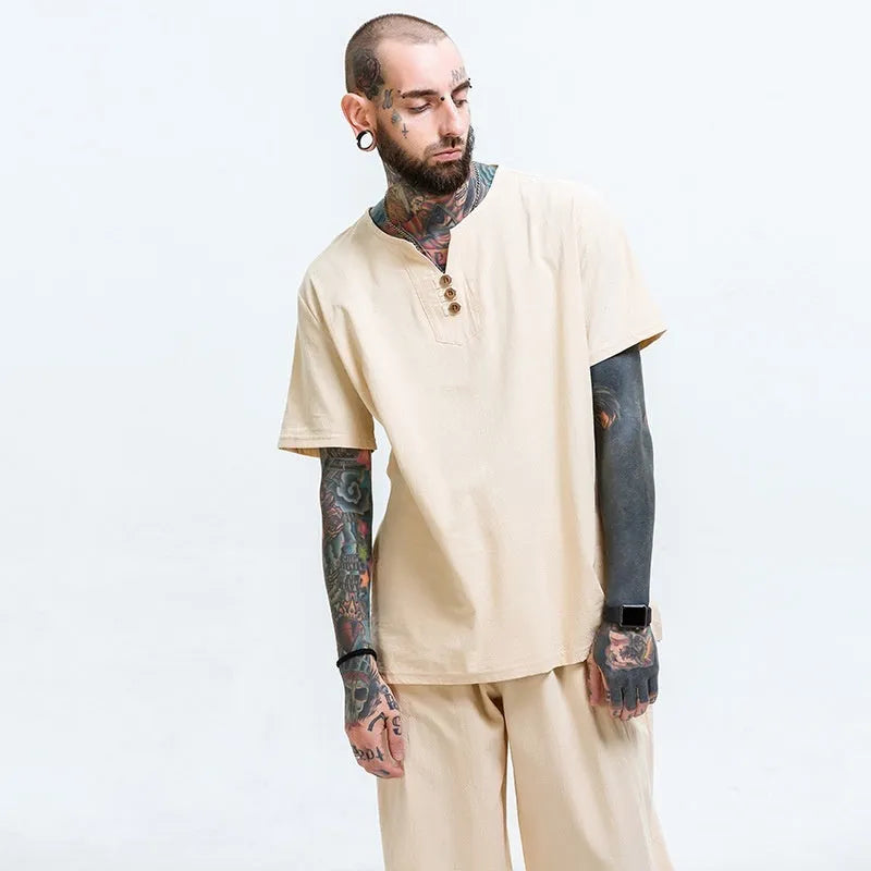 Man wearing a loose apricot coloured cotton linen blend t-shirt, showing the relaxed short sleeve pullover style.