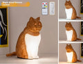 Decorative table lamp with cat ornaments featuring USB charging port and adjustable colour temperature settings