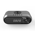 Space grey wireless charging alarm clock with Bluetooth speaker and LED display.