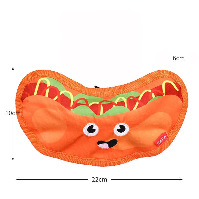 Set of four colourful fast-food shaped dog toys: hamburger, fries, hot dog, and pizza, featuring crinkle and squeak sounds.