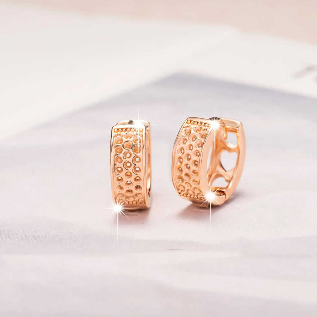 Rose gold hollowed-out heart earrings with circular 2.5cm diameter on white background