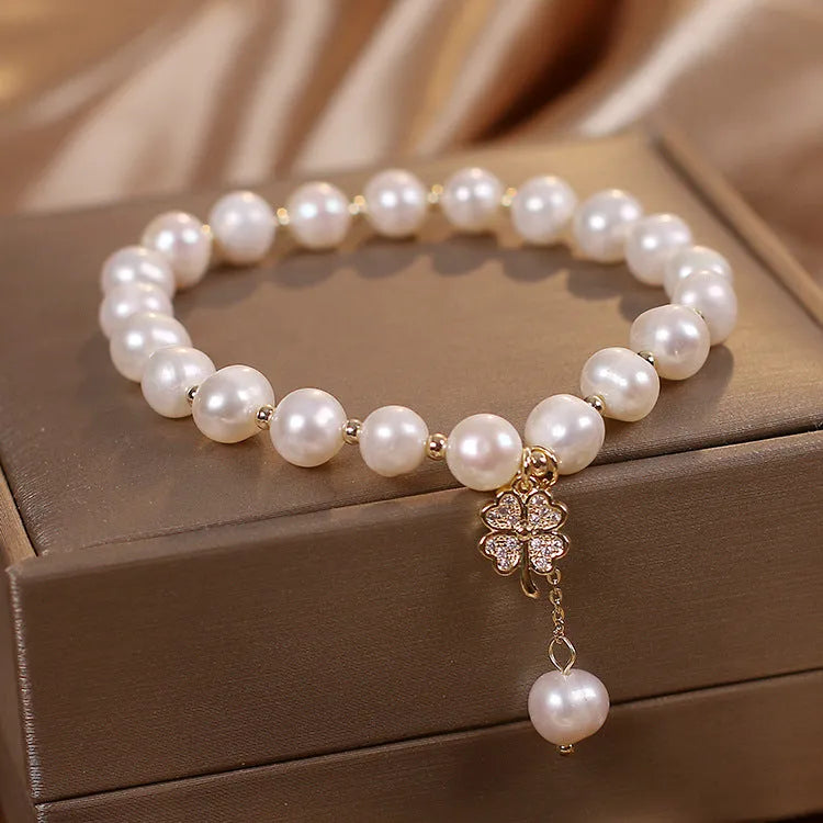 White freshwater pearl bracelet with four-leaf clover charm, alloy material, and sequin detail for women