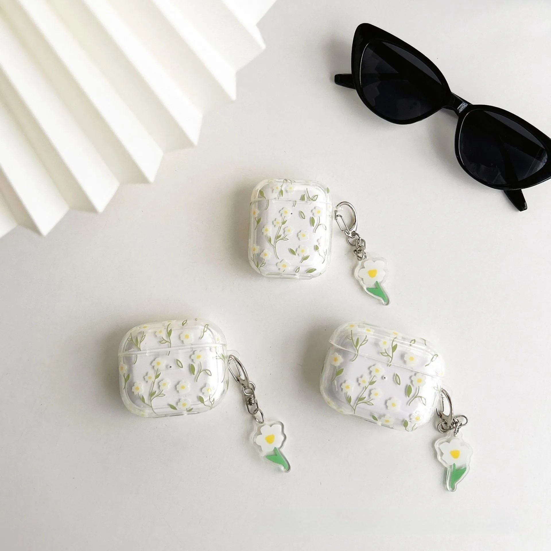 White floral design AirPods protective cover showing high-transparency TPU material and decorative elements