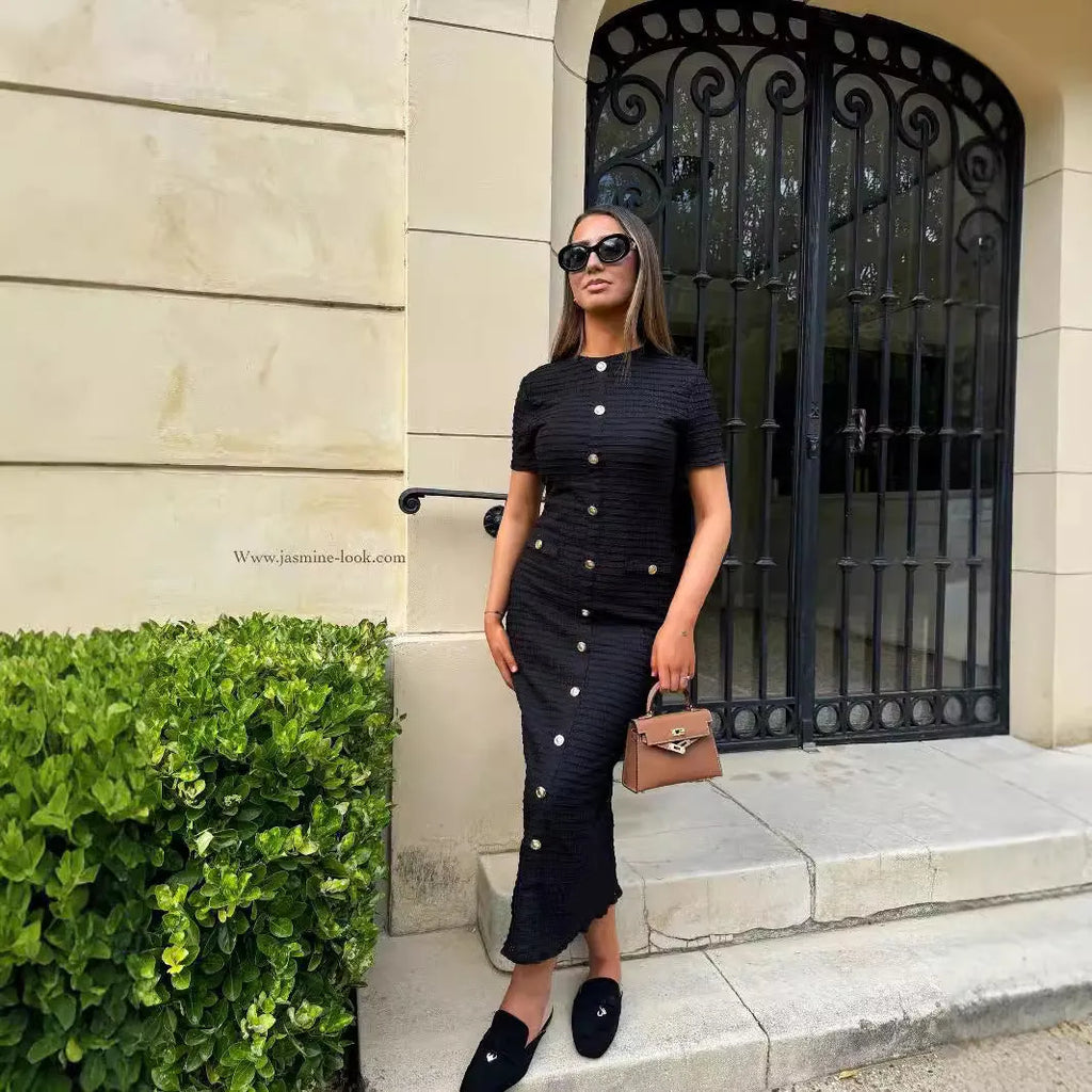 Retro French slim fit knitted long sleeve dress in black with button detail and a one-step skirt.
