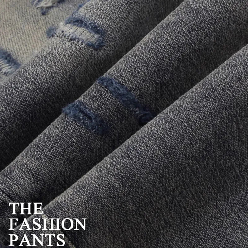 Men's slim fit distressed jeans with embroidered patches in an old colour wash.
