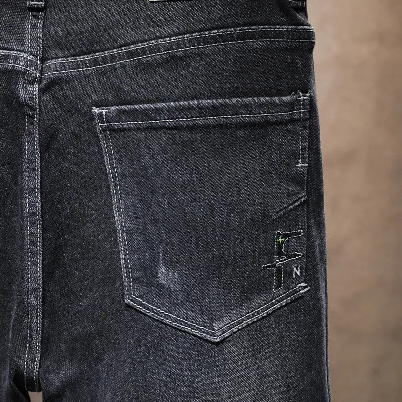 Men's dark grey loose straight-leg cotton denim jeans with mid waist, zip fly and cat whisker finish