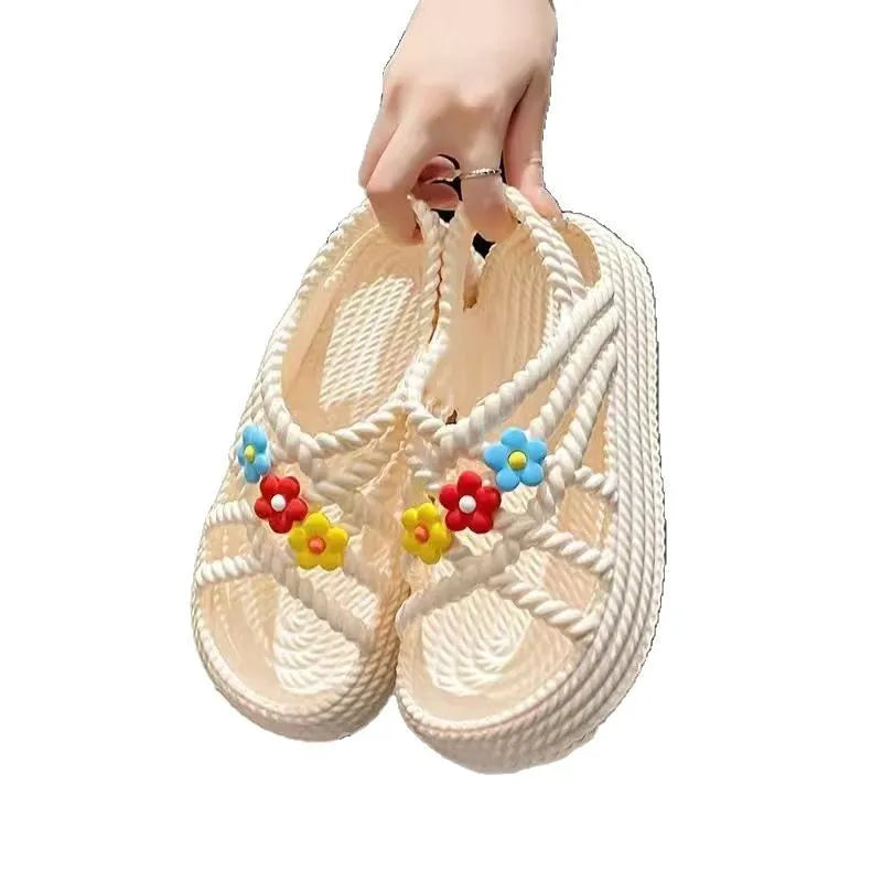 PVC round-toe sandals with a non-slip sole in beige colour with a sunflower decoration.