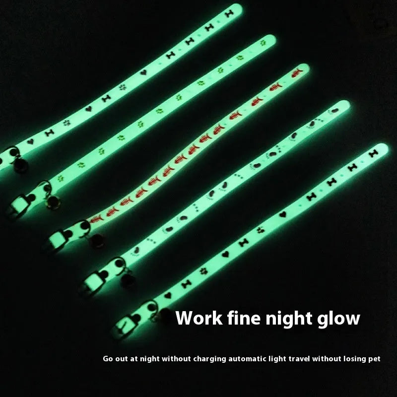 Luminous cat collar with a metal bell on an adjustable 29cm silicone strap, showing paw print design.