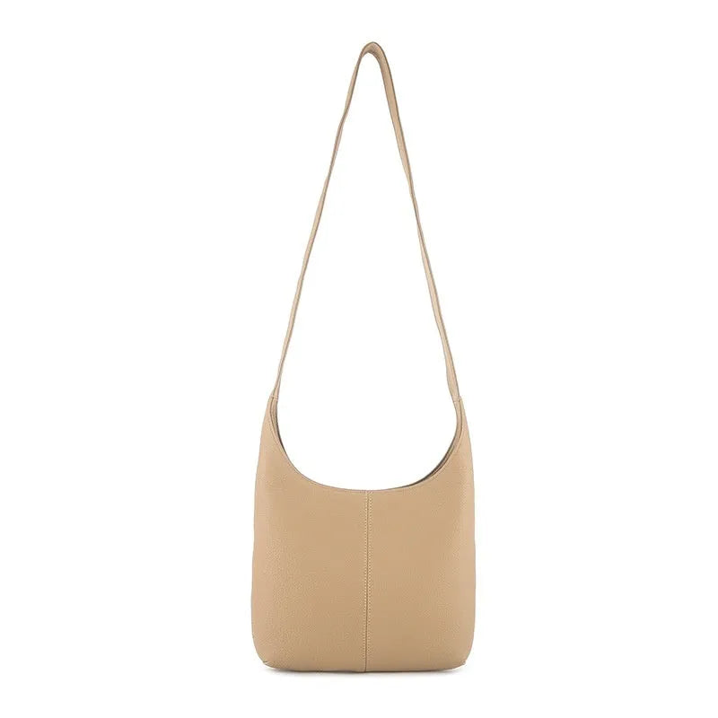 Leather women's casual zip crossbody bag in top grain genuine leather with canvas lining and open outer pocket.