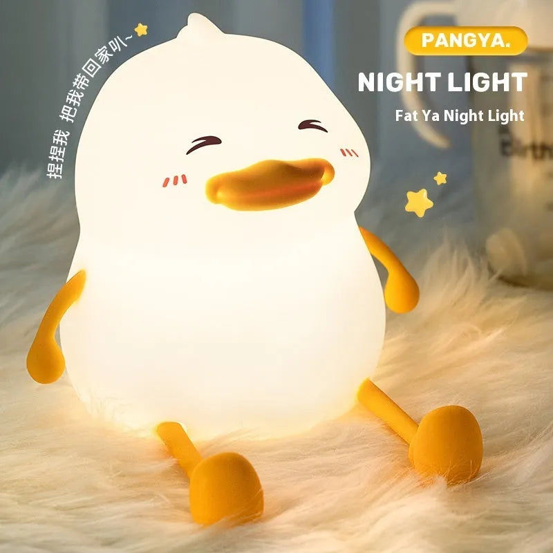 Chubby Night Light TW-L73 on desk showing silicone phone holder with mobile device and adjustable brightness settings