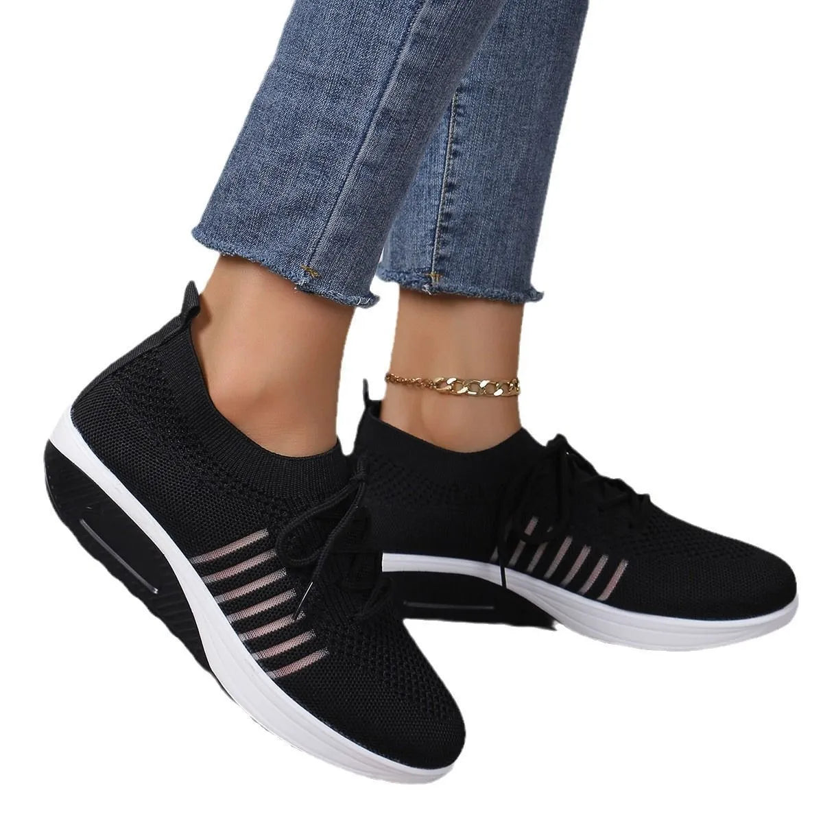 Black mesh platform lace-up flat shoes with a round toe and rubber sole on a white background.